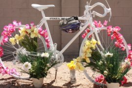 People have added more flowers and a helmet to Paula's ghost bike (April 18,2010)