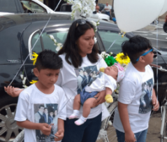 Gelacio Reyes’s wife Flor Jimenez and their three children at Saturday’s memorial. Photo: Macartney Morris